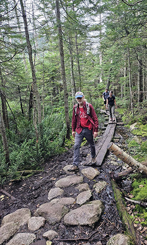 professor and students hike during off-campus project