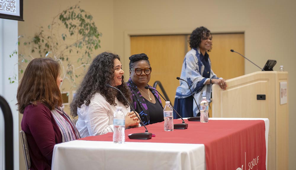 Participants engage in a discussion during a Business Week panel in the Odeum.