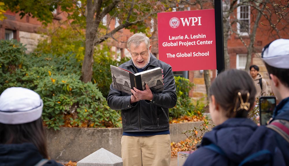 Stephen Kmiotek reads from a book during Founders Day festivities.
