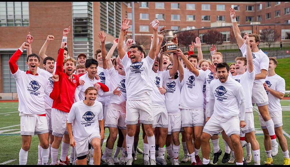The men's soccer team celebrates after winning a championship.