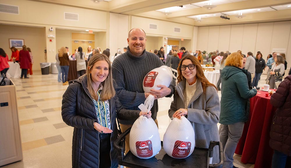 Staff members pose with turkeys they won during the Harvest of Thanks Staff Appreciation Event.