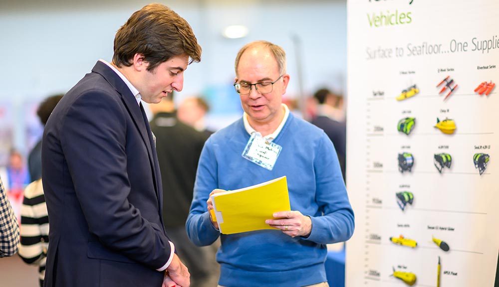 A student meets with an employer at the latest career fair.