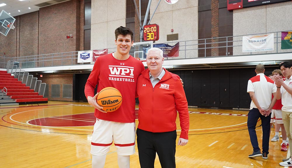 John Adams '24 with the head men's basketball coach following his 1,000-point milestone.