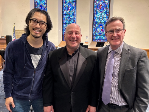 Binan Gu, Mitchell Lutch, and Thomas O'Toole pose for photo inside concert hall at Worcester Area Mission society
