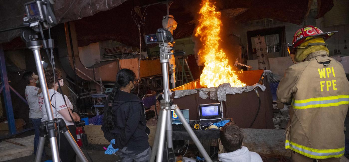 students studying flames in WPI fire lab