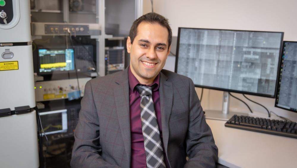 Shahin Tajik sits in a WPI computing center.