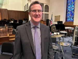Thomas O'Toole stands in hall at Worcester Area Mission Society following concert performance