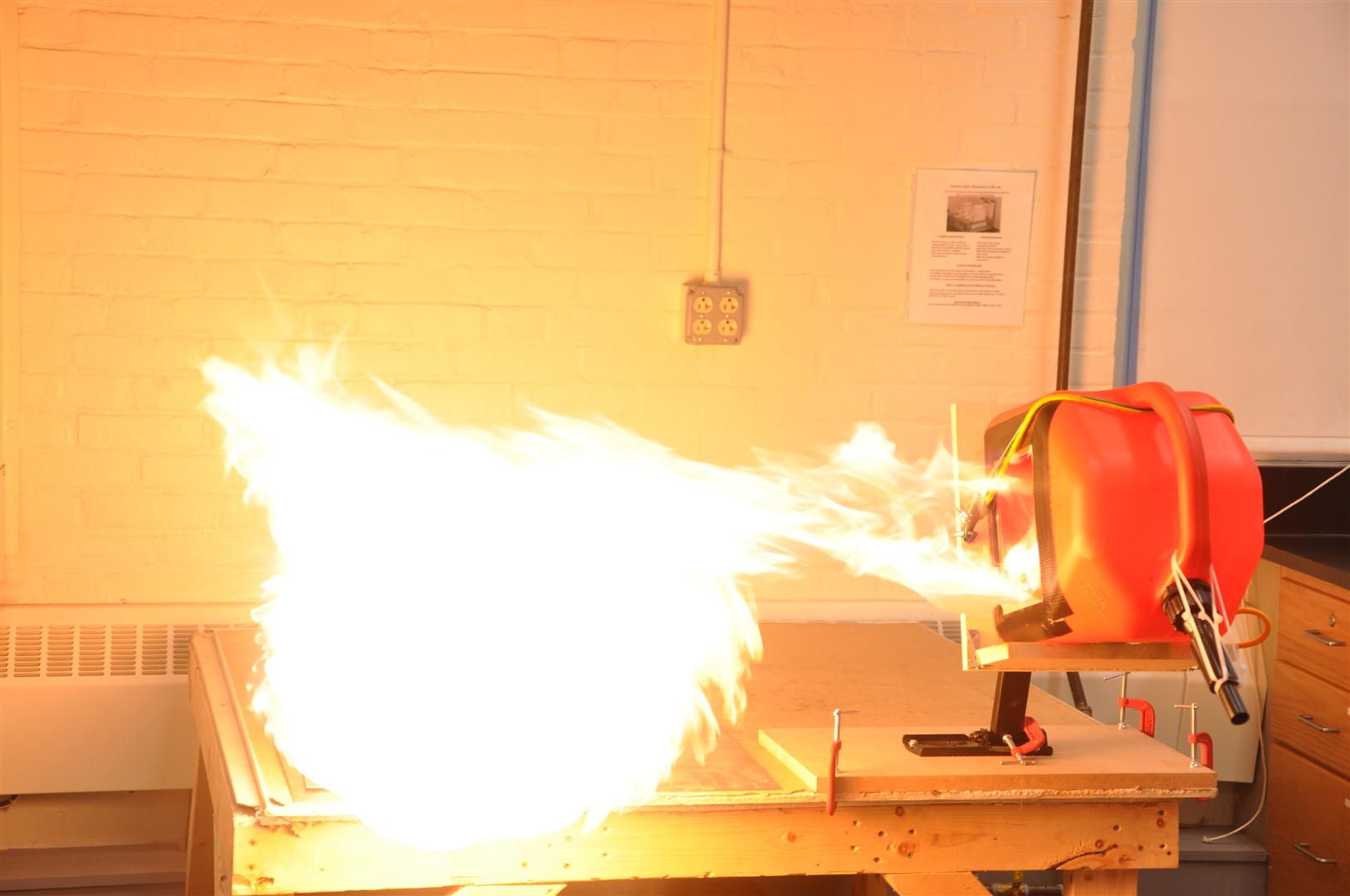 Large, bright flame emanating from a red fuel can