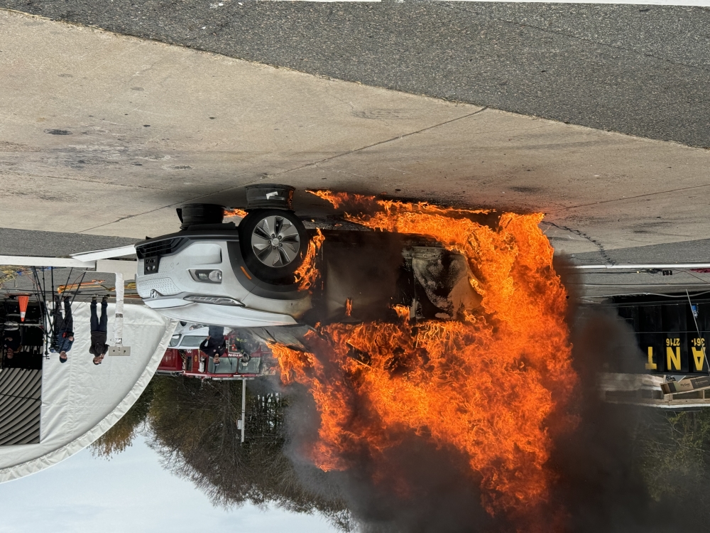 Electric vehicle is ingulfed in flames at a site where firefighters, researchers, and students conducted a research burn.