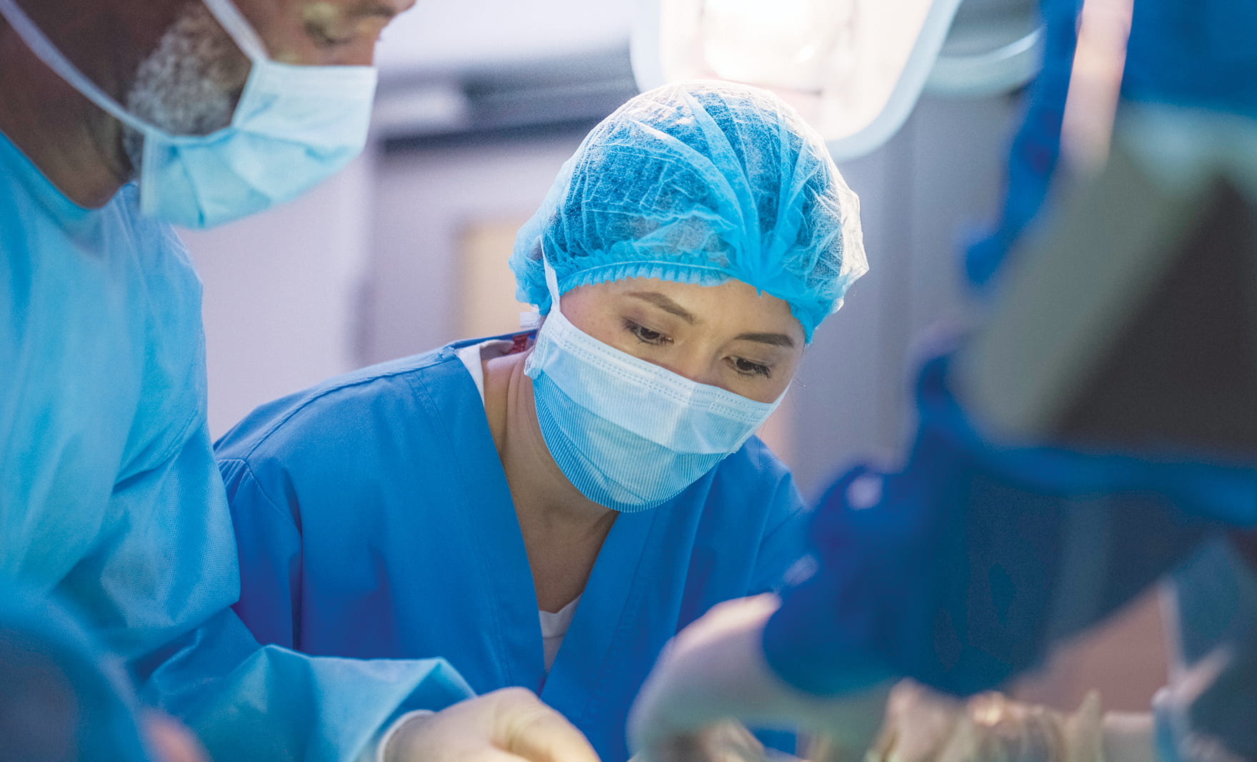 Photo of two doctors in scrubs and masks.