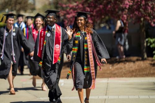 students smiling as they finish the bridge crossing