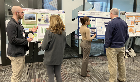 Research Experiences for Teachers (RET) Students discuss their project with attendees at the STEM Education Center Showcase.