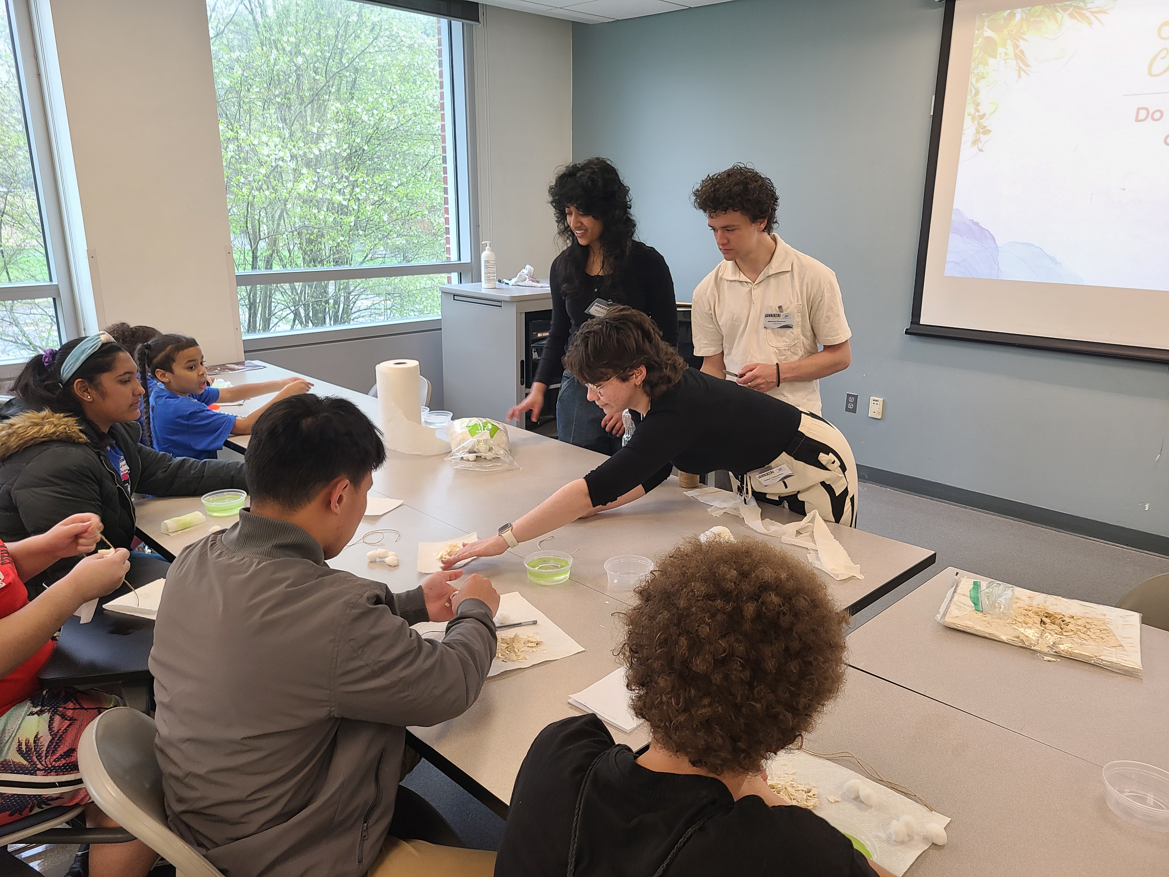 WPI students Meera Sridhar, Mechanical Engineering, Jules Vekiarides, Mechanical Engineering, and Michael Zamora, Chemical Engineering, facilitated “Removing Harmful Algae Blooms from Worcester Lakes” - an activity where students designed a solution to remove algae from simulated lakes.