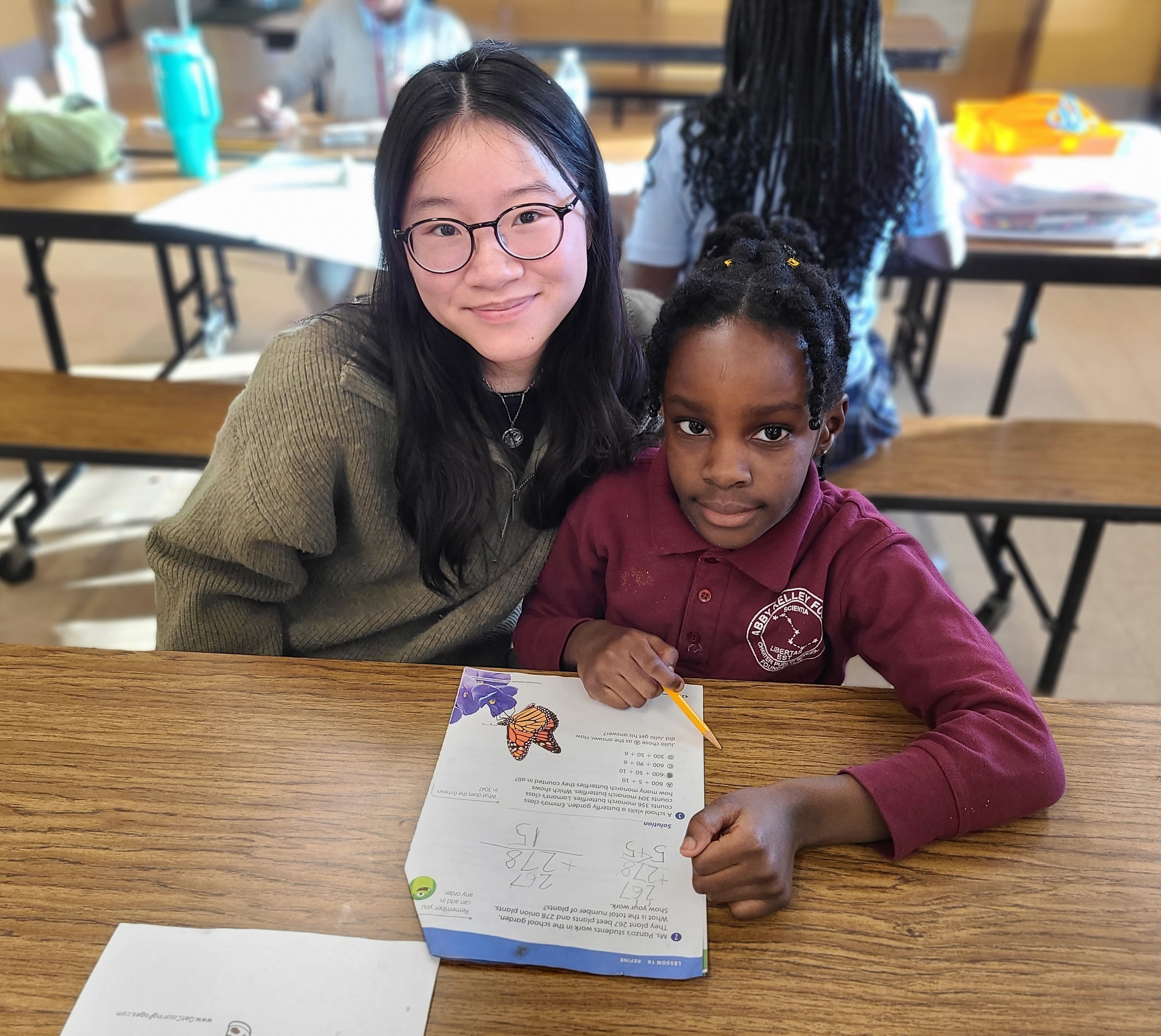 WPI student, Grace Ho, assists a student with homework.