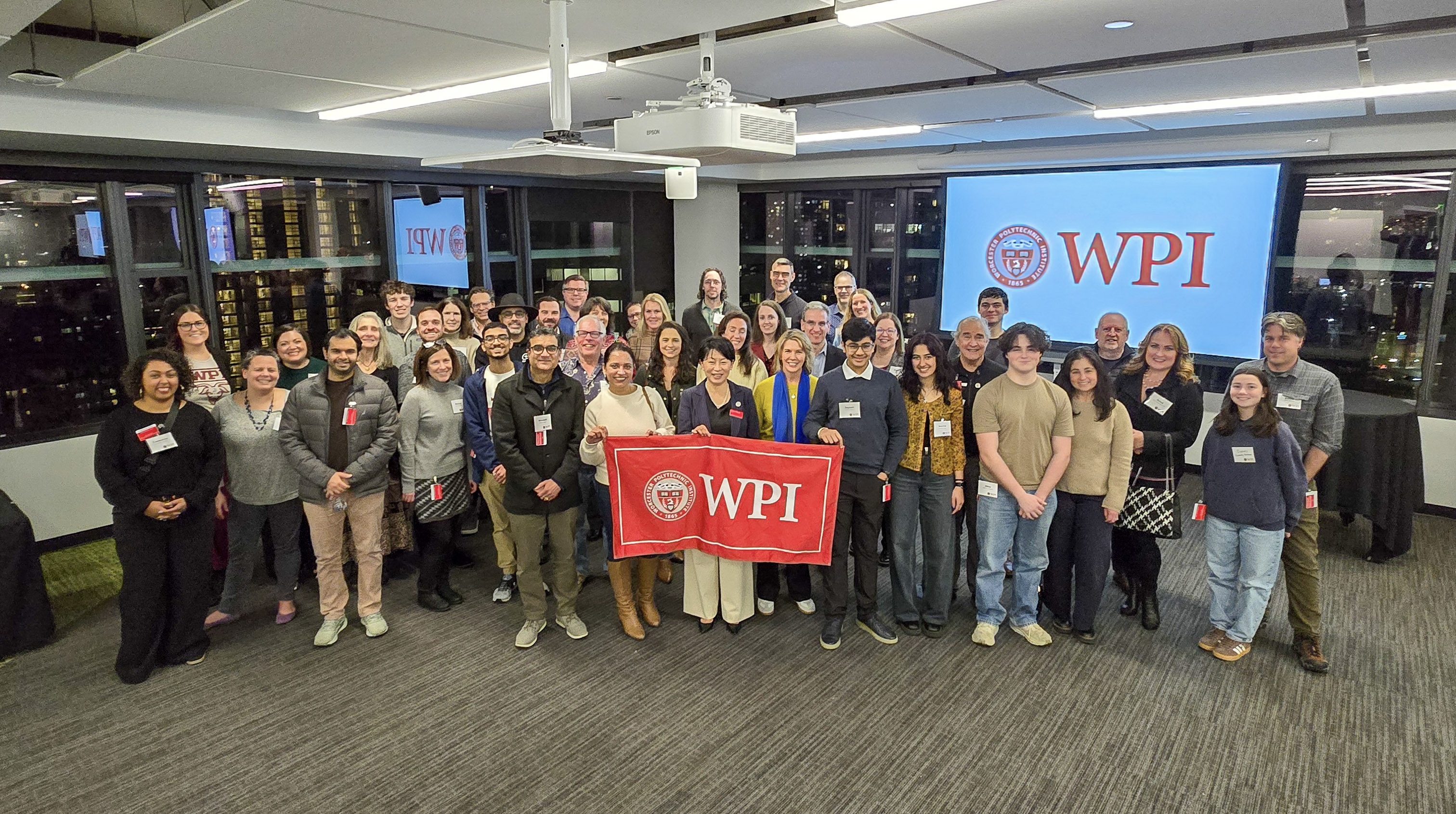 Group of people in front of a background saying WPI