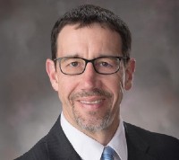 Daniel Linzell headshot in a suit and tie
