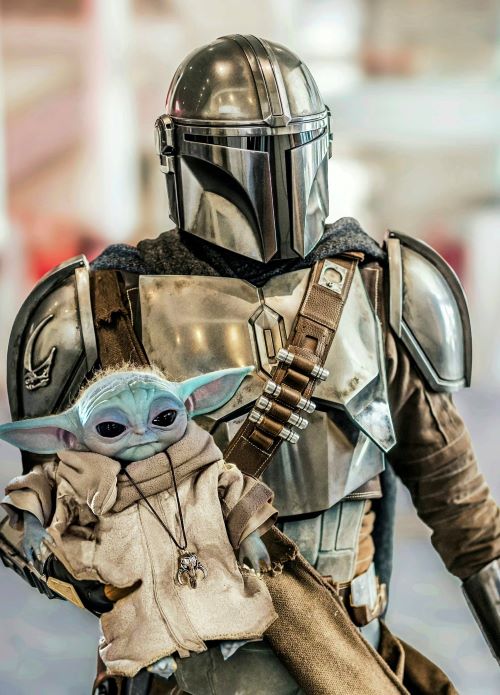 Sutter in the Mandalorian costume he constructed, with the Grogu puppet he and Winchell created at WPI.