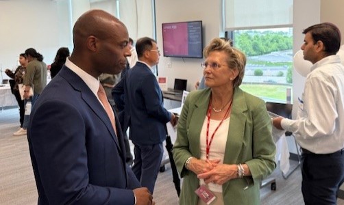 Susanna Perkins speaks with a guest at a WPI open house held to showcase the university's shared research facilities.