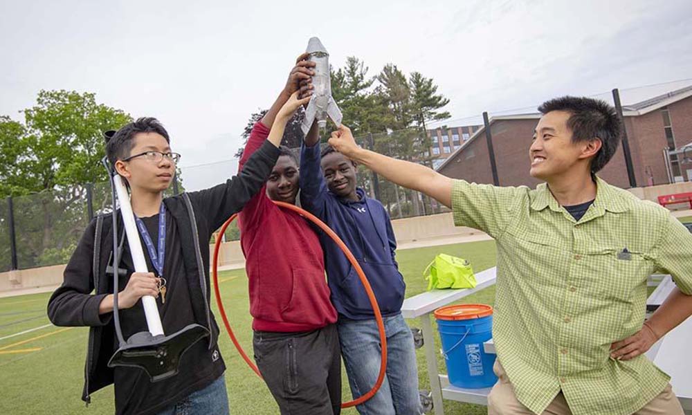 Team of kids celebrating their rocket design