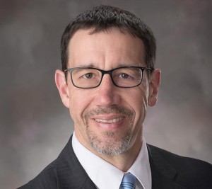 headshot of Dean Linzell wearing a suit and tie