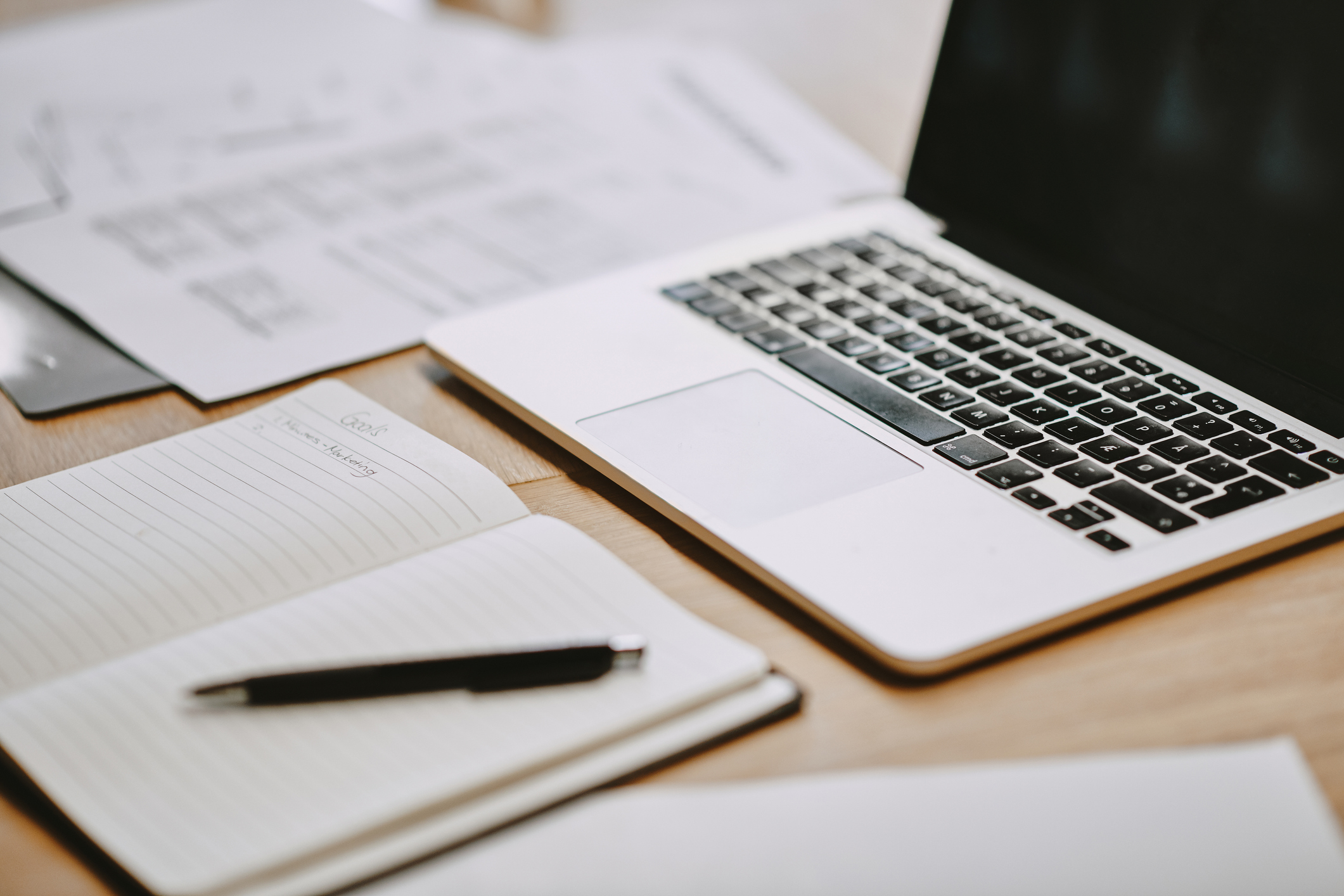 laptop sitting on table with notebooks and coffee