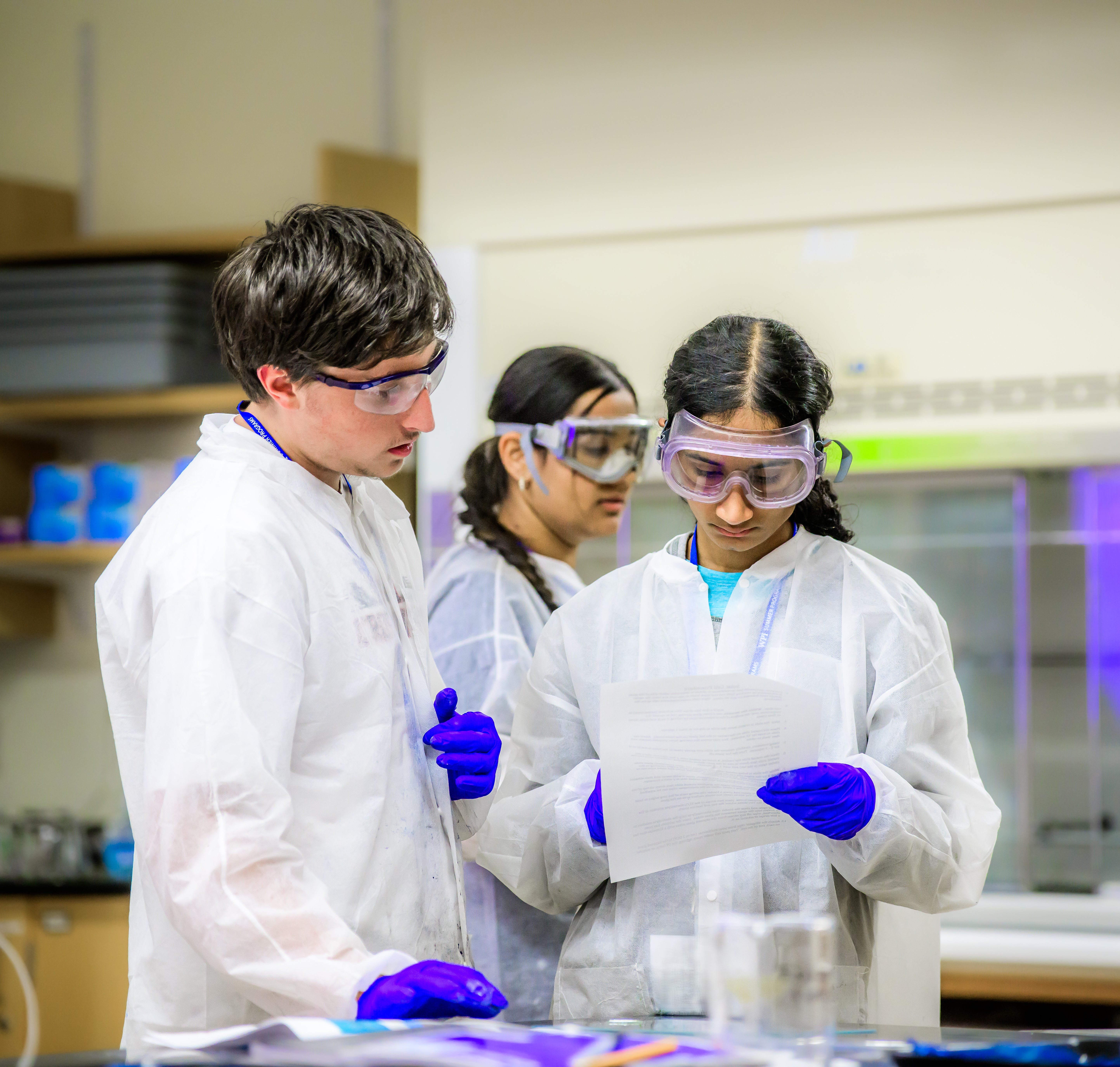 Students in a lab reading lab notes