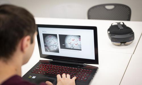 student working on brain imaging with AI