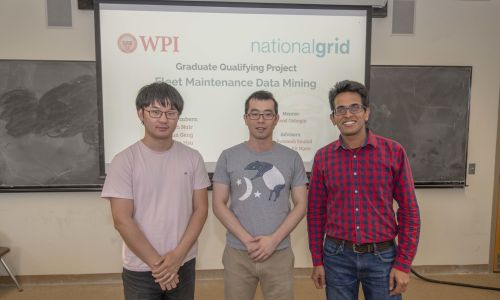 GQP poster presentation with 3 people standing in front of display