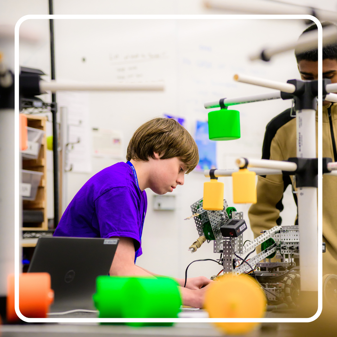 Male student working on a robot
