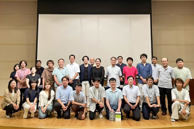 group standing on a stage for a photo