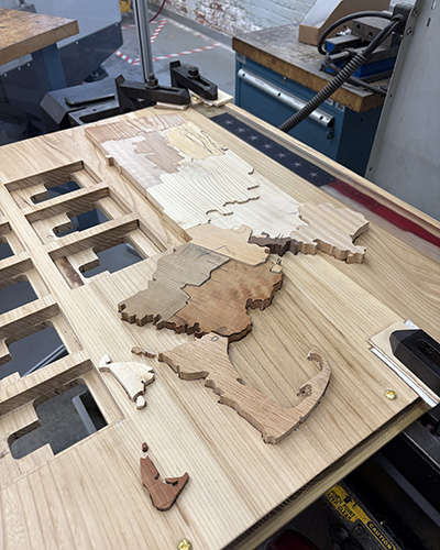 A wooden map of Massachusetts with each of its 14 counties constructed from a different type of wood.