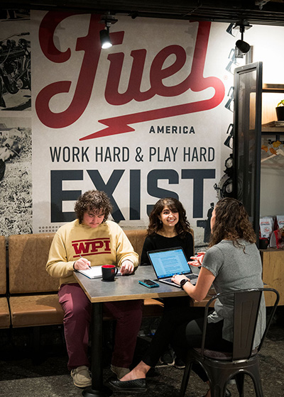 three people sitting at a table at Fuel Coffee Shop
