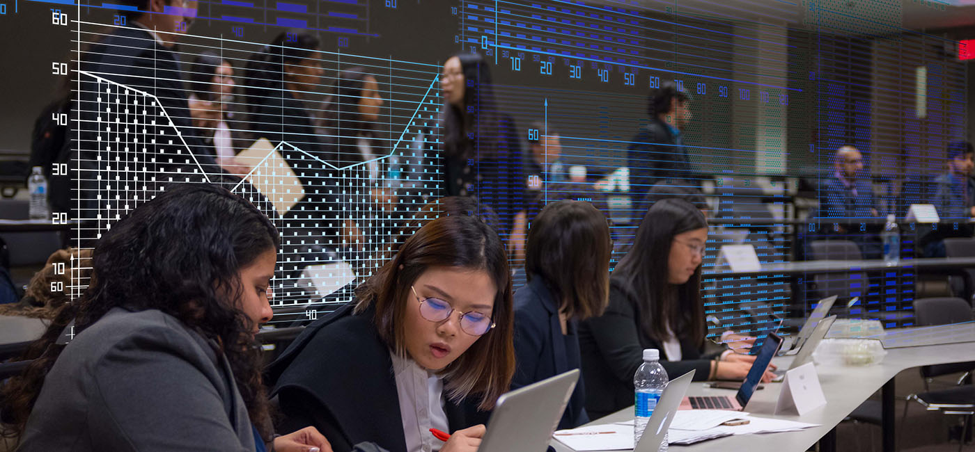 WPI Business School students working in a modern classroom with a financial and tech overlay