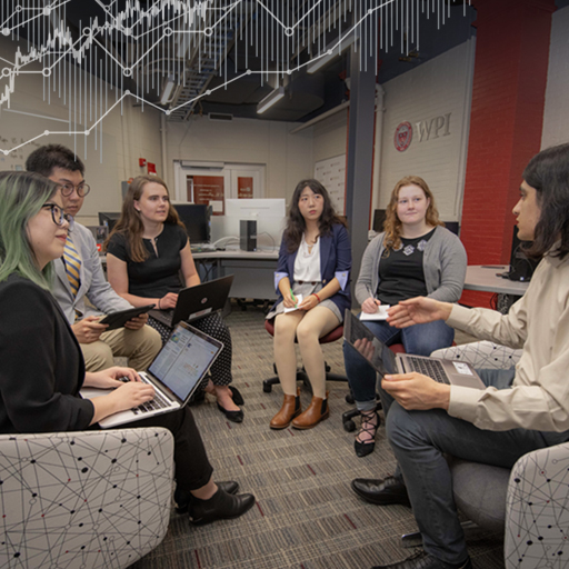 WPI Business School students meet in a circle in one of the school's business labs.