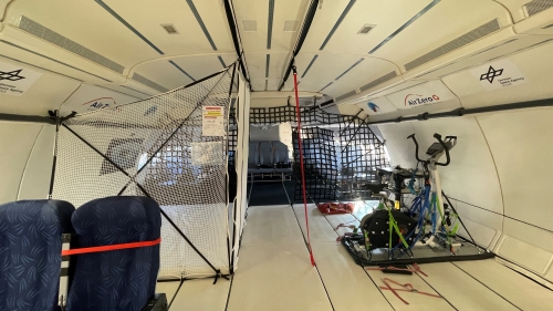 Inside the passenger area of a commercial jet, with seats removed