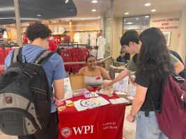 students interacting at a table sitting