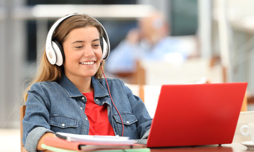 Student on Computer with Headphones