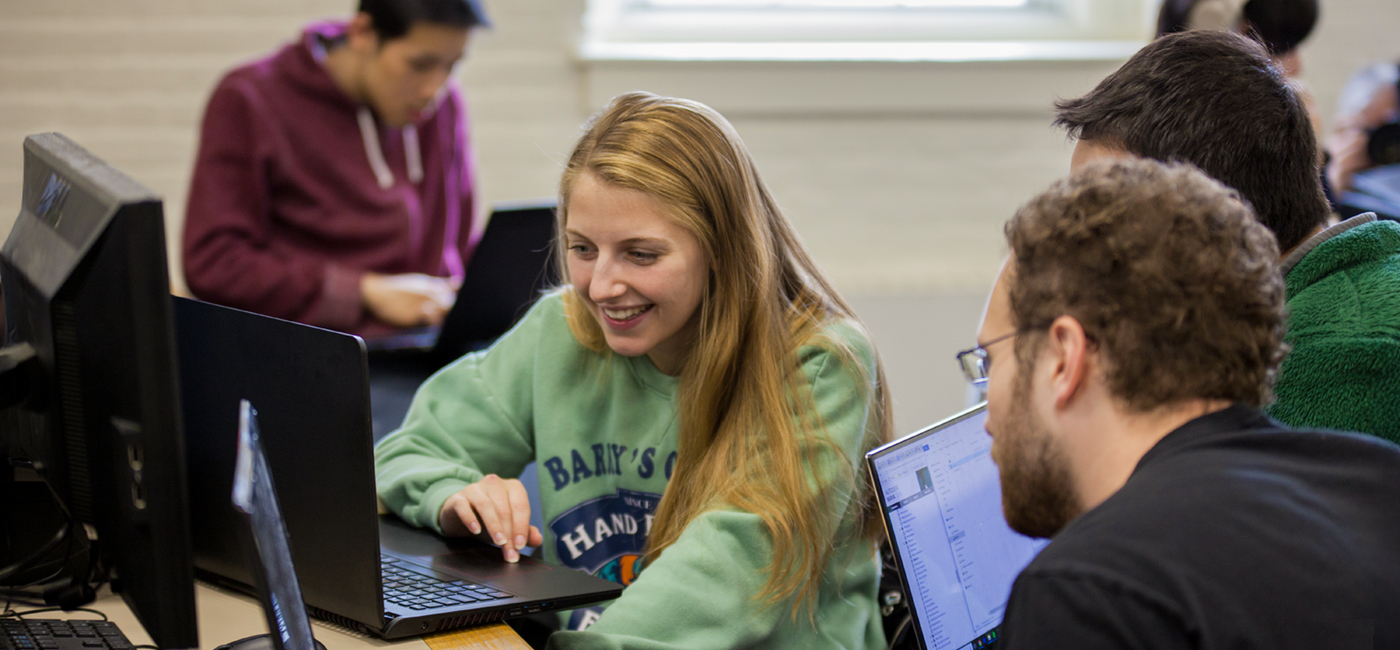 WPI students huddled with laptops