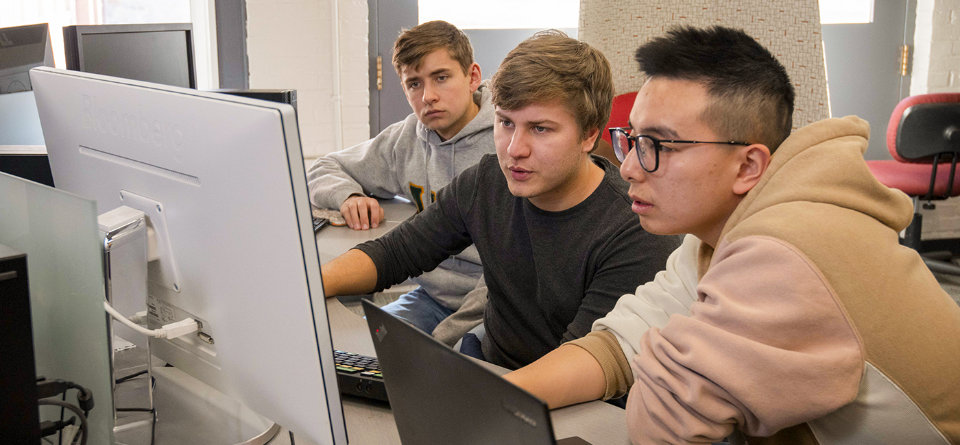 WPI Students huddled around computer