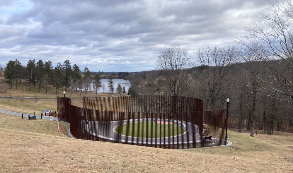 memorial with raised thin columns in a semi-circular design in a field