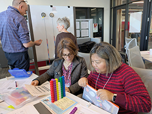 Two attendees at the STEM Education Showcase working together in a session