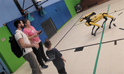 Amanda Gallerani  showing a student a robot