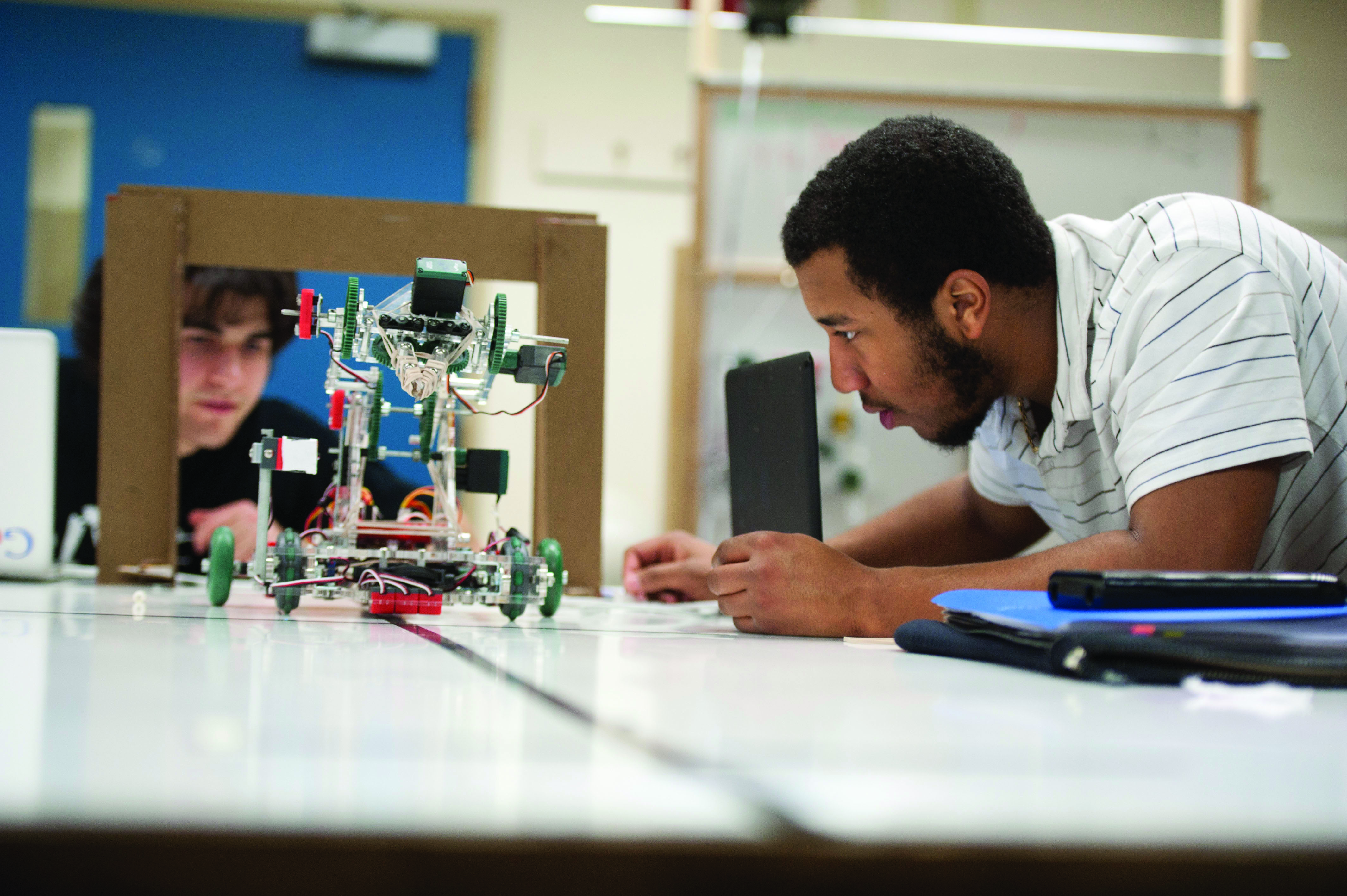undergraduate student working on a robot at WPI