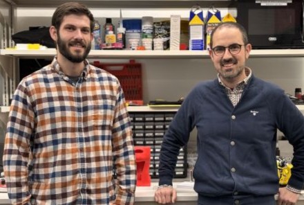 Two men stand in a lab