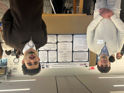 two male students in front of poster board