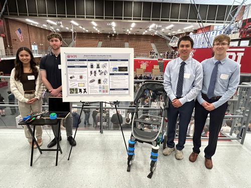 students in front of poster and next two prototyped baby carriage
