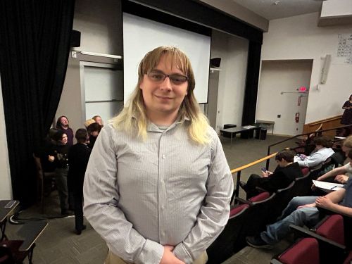 student posing in lecture hall