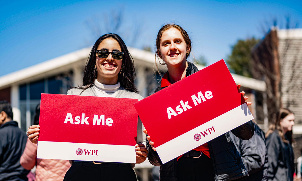 Two friendly WPI students helping guests with a tour of the campus