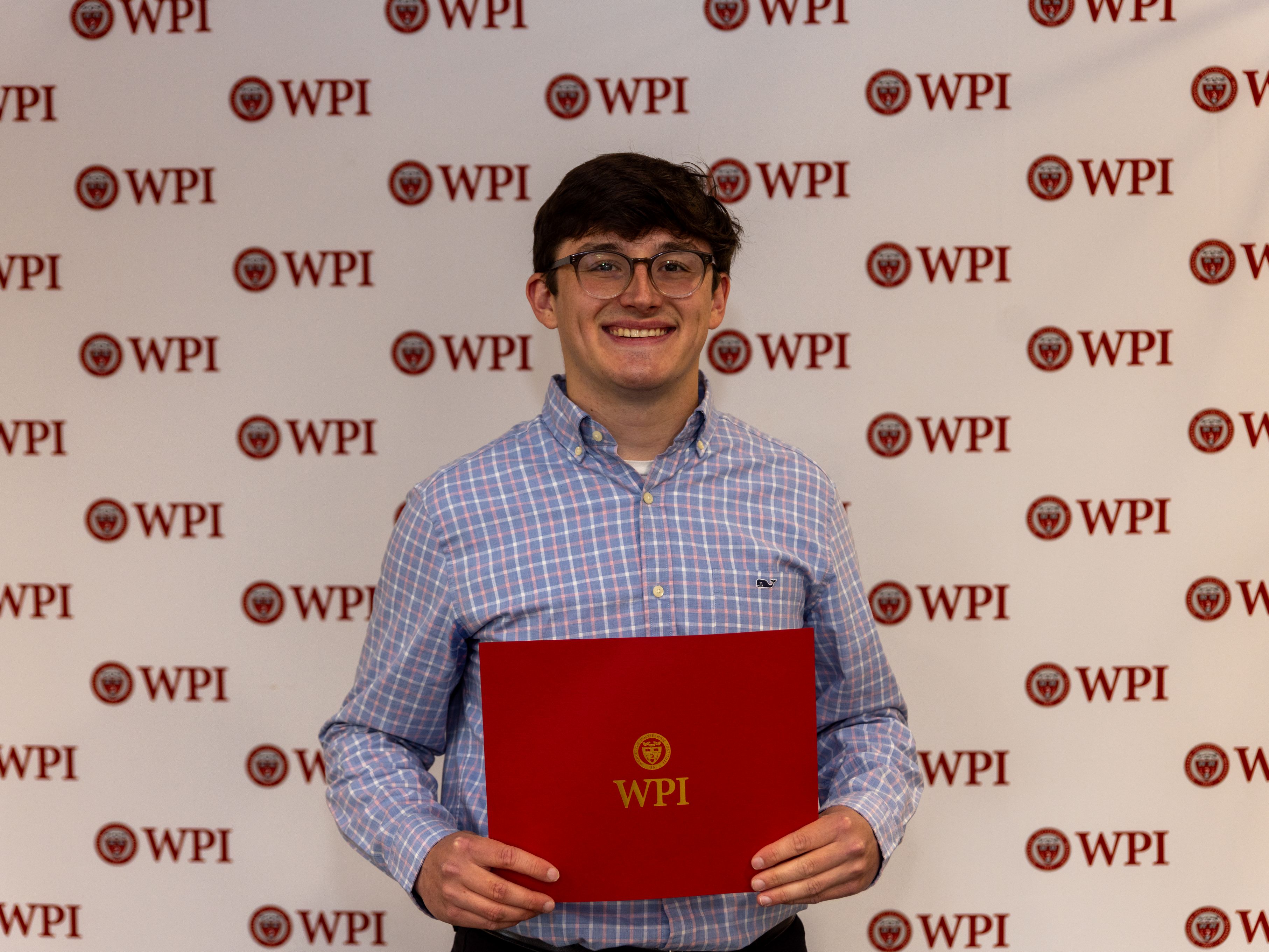 Evan Carmody Holding Student of The Year Award Certificate