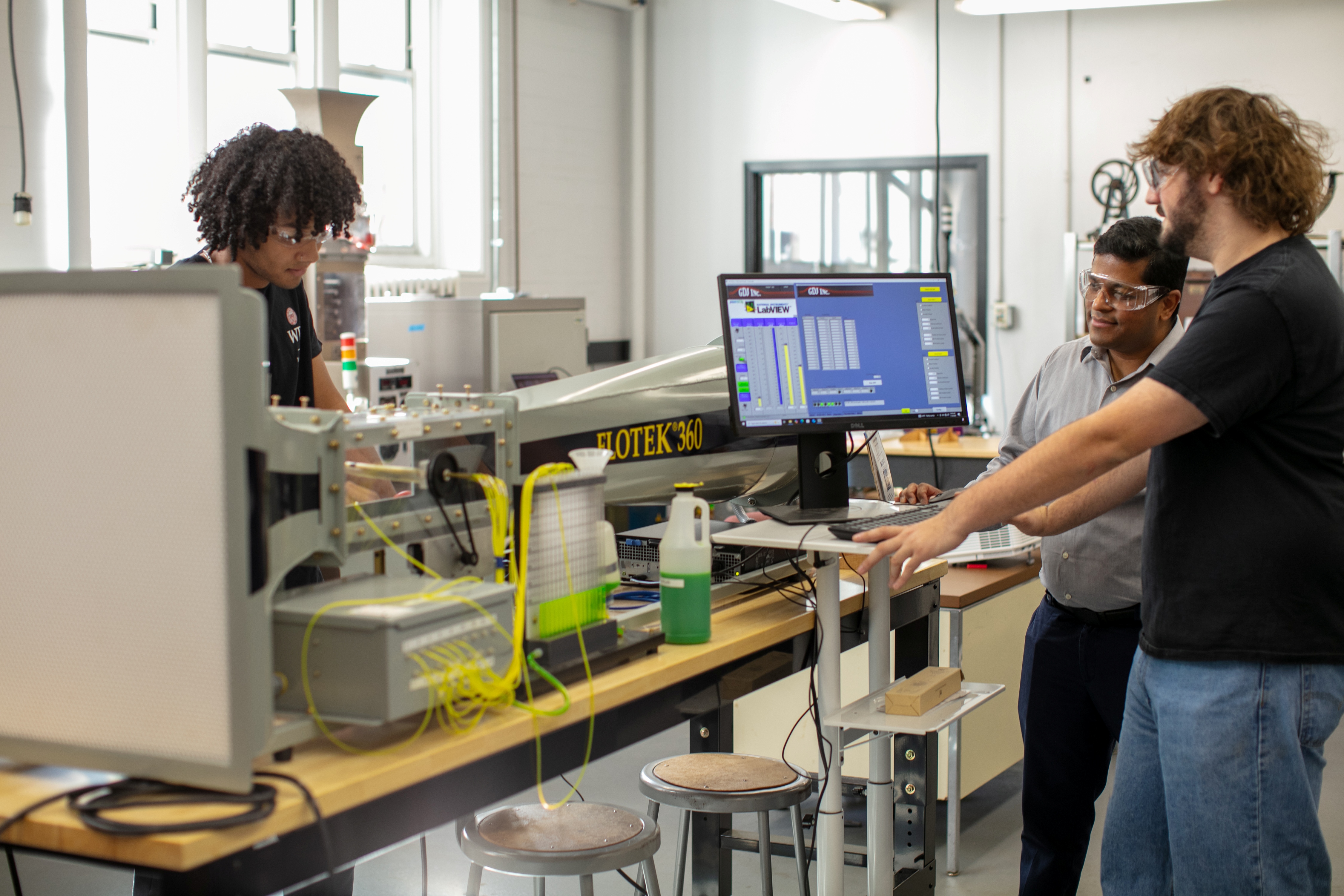 men working in lab with tech